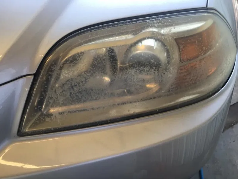 Gold car — headlight restoration — before