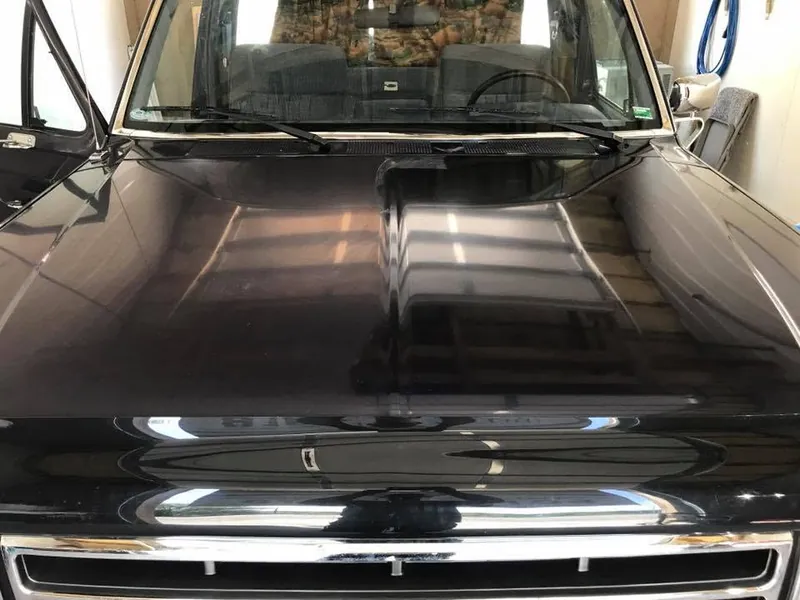 Black car (hood/paint detail) — exterior after detailing