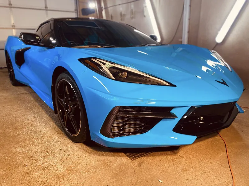 Blue sports car with a deep gloss finish in the detailing bay