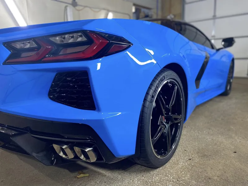 Rear three-quarter view of a blue sports car after ceramic detailing
