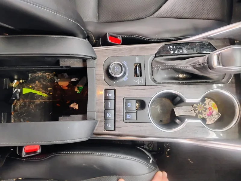 Grey vehicle interior — center console, before deep-clean
