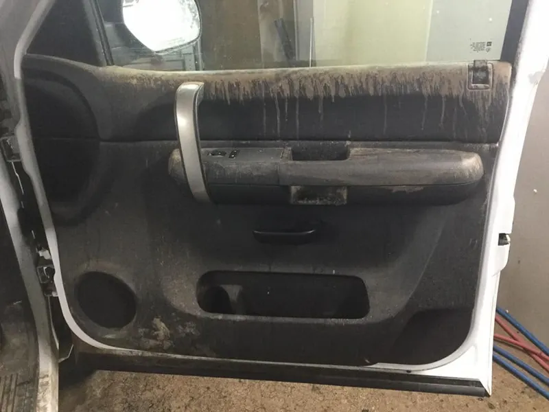 Grey pickup-truck interior — deep-clean detail (driver door panel) — before