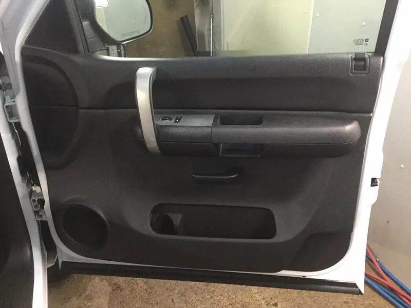 Grey pickup-truck interior — deep-clean detail (driver door panel) — after
