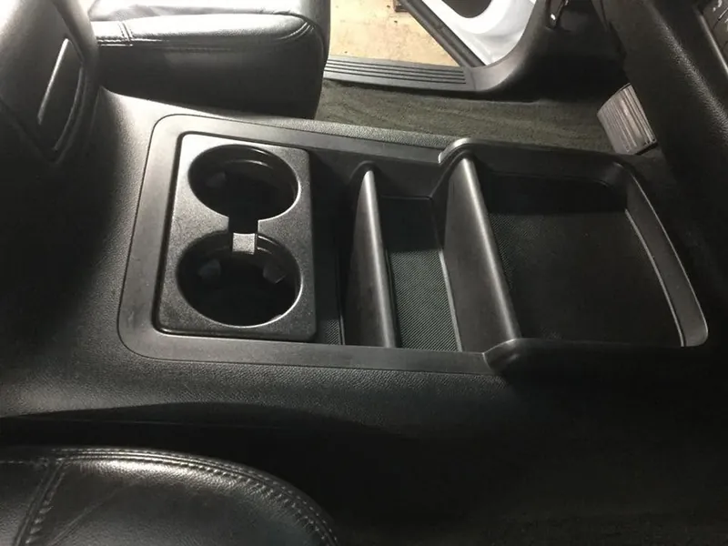 Black pickup-truck interior — deep-clean detail (center-console cup holders)